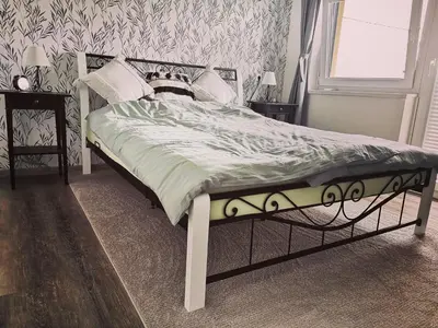a bedroom with a bed with a metal frame at Počitniška hiša Pavlek in Ivanjkovci