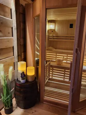 a sauna with two lamps and a barrel at Hiša stare mame in Kamnik