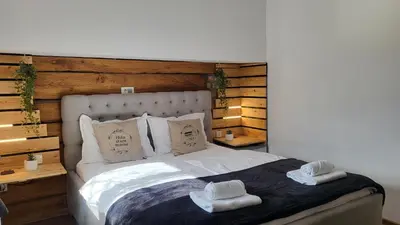 a bedroom with a bed with two towels on it at Hiša stare mame in Kamnik