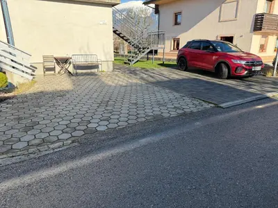 a red car parked on the side of a street at Apartments Mici in Bled