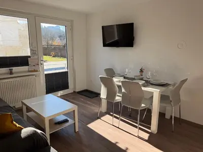 a living room with a dining room table and chairs at Apartments Mici in Bled