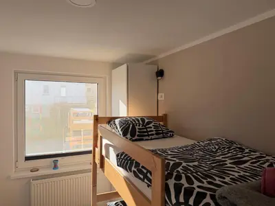 a bedroom with a zebra print bed and a window at Apartments Mici in Bled