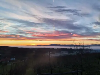 a sunset in the sky with a view of the ocean at Počitniška hiša Parkfield Dragovan in Metlika