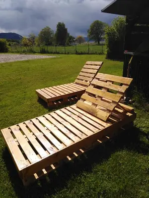 a group of wooden benches sitting in the grass at APP PARCELA CELJE in Celje