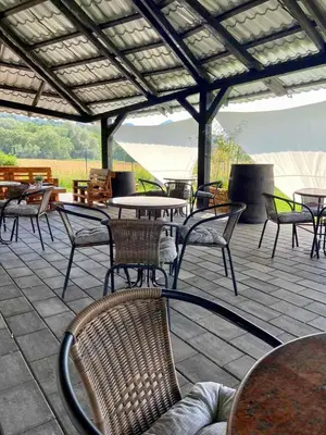 an outdoor patio with tables and chairs and tables and chairs at APP PARCELA CELJE in Celje