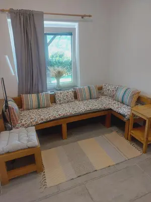 a couch in a living room with a window at APP PARCELA CELJE in Celje