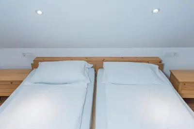 two beds sitting next to each other in a room at Holiday House Destina - Lake Bohinj in Bohinj