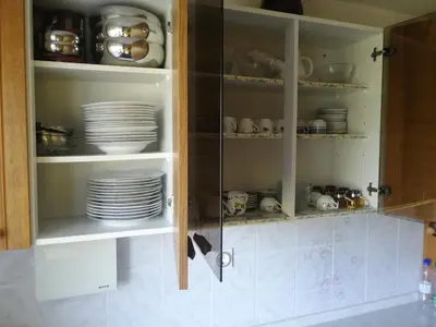 a cabinet filled with plates and cups and dishes at Apartma Gorca Plevnik in Buče