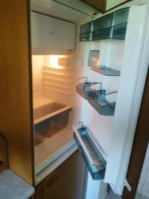an empty refrigerator with its door open in a kitchen at Apartma Gorca Plevnik in Buče