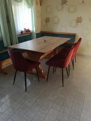 a wooden table and chairs in a room at Apartma Gorca Plevnik in Buče