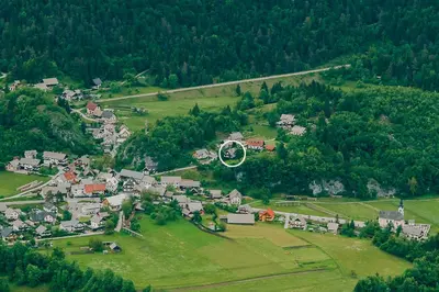 an aerial view of a small village in a green field at Spacious apartment in Bled