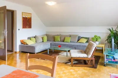 a living room with a couch and a table at Spacious apartment in Bled