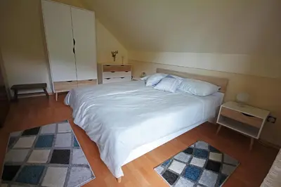 a bedroom with a large white bed in a room at Spacious apartment in Bled