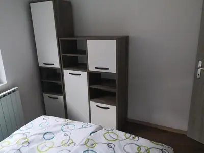 a bedroom with a bed and a dresser and a mirror at Apartma Alja Podkoren in Kranjska Gora