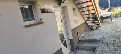 a door to a building with a sign on it at Apartma Alja Podkoren in Kranjska Gora