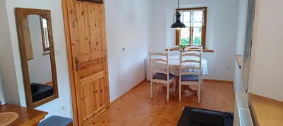 a dining room with a table and chairs in a room at Apartment Perunika in Cerkno