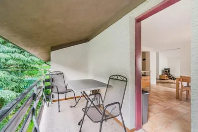 a balcony with a table and chairs on it at Vila Labod, unique villa at the lake in Most na Soči