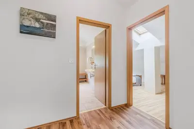 a hallway with a mirror and a painting on the wall at Vila Labod, unique villa at the lake in Most na Soči
