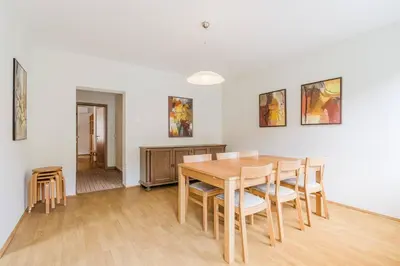 a dining room with a wooden table and chairs at Vila Labod, unique villa at the lake in Most na Soči