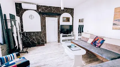 a living room with a couch and a tv at LTE Apartments in Maribor