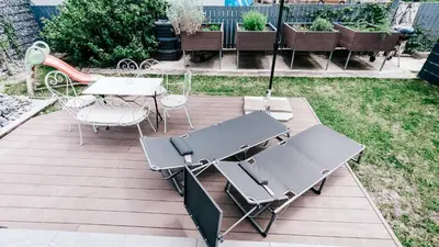 a patio with a table and chairs and an umbrella at LTE Apartments in Maribor