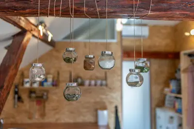 a group of glass lights hanging from a ceiling at LTE Apartments in Maribor