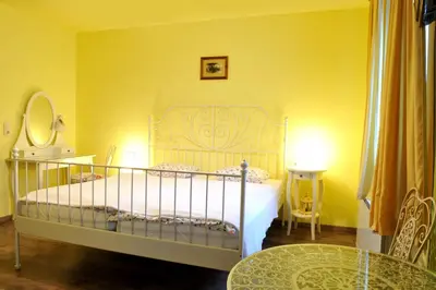 a bedroom with a bed and a table and a mirror at Gostilna in Prenočišča Brančurnik in Prevalje