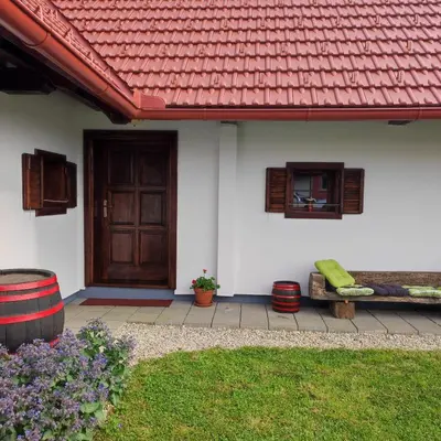 a white house with a red roof and a door at Vorgova klet in Bogojina