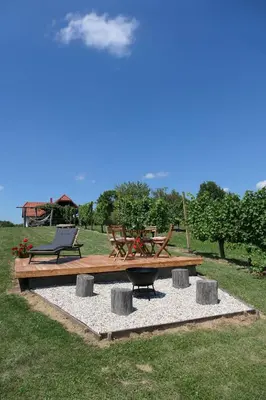 a picnic table and bench in a field at Vorgova klet in Bogojina
