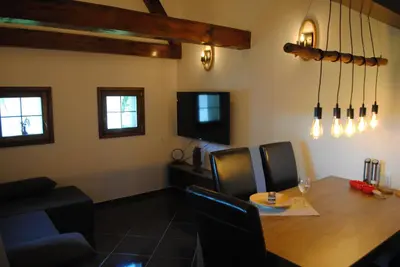 a dining room with a table and a tv at Vorgova klet in Bogojina
