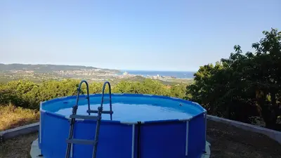 a blue hot tub sitting on top of a hill at Apartma Nona Roža in Zgornje Škofije