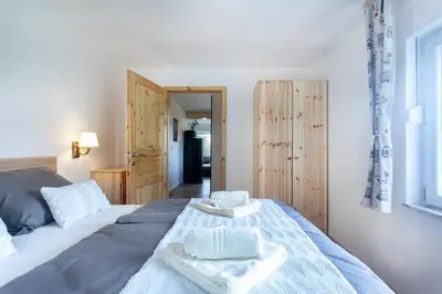 a bedroom with a bed with two towels on it at Honey apartments in Žirovnica