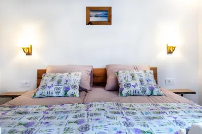 a bedroom with a bed and two pillows at Honey apartments in Žirovnica