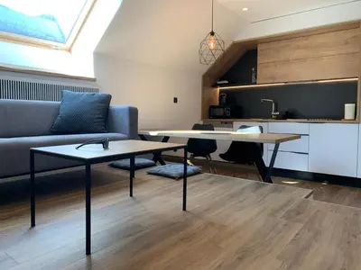 a living room with a table and a couch at 18Home apartments, Mojstrana in Mojstrana