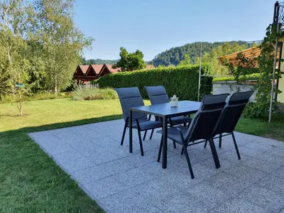 a table and four chairs on a patio at Green Oasis Anica in Podčetrtek