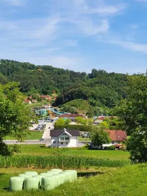 a group of hay bales in a field next to a park at Green Oasis Anica in Podčetrtek