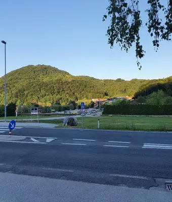 an empty street with a mountain in the background at Green Oasis Anica in Podčetrtek