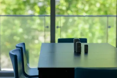 a table and chairs in a room with a window at Sunrise Maribor apartment with private parking in Maribor