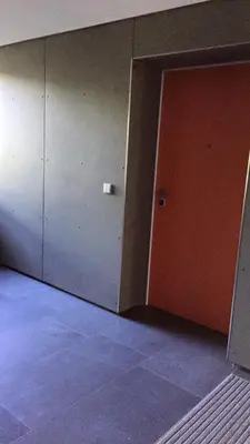 an empty room with a door and a wall at Sunrise Maribor apartment with private parking in Maribor