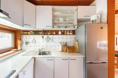 a white kitchen with a sink and a refrigerator at Holiday Home Bela in Bohinjska Bela