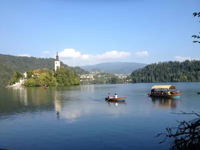 two boats on a lake with people in them at Holiday Home Bela in Bohinjska Bela