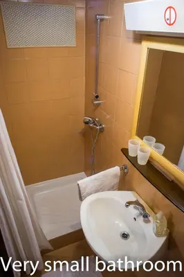a small bathroom with a sink and a bath tub at Apartments and Rooms Villa Vive in Bled