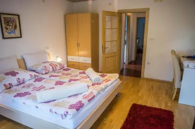 a bedroom with a bed with towels on it at Apartments and Rooms Villa Vive in Bled