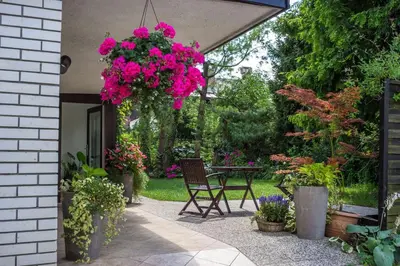 a patio with a table with a bunch of flowers at Apartments and Rooms Villa Vive in Bled