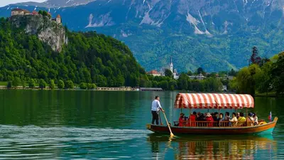 a group of people on a boat on a lake at Apartments and Rooms Villa Vive in Bled