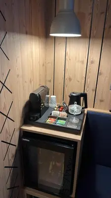 a desk with a phone and a lamp in a room at Na Vasi restavracija in prenočišča in Škofja Loka