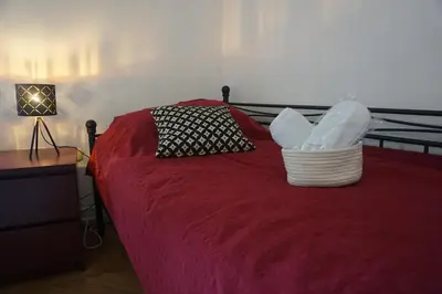 a bedroom with a red bed with a basket on it at Villa Hortensia in Ljubljana