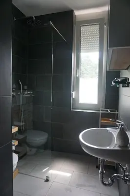 a bathroom with a sink and a toilet and a window at Villa Hortensia in Ljubljana
