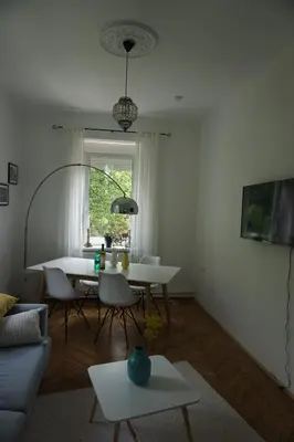 a living room with a white table and chairs at Villa Hortensia in Ljubljana