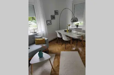 a living room with a table and a dining room at Villa Hortensia in Ljubljana